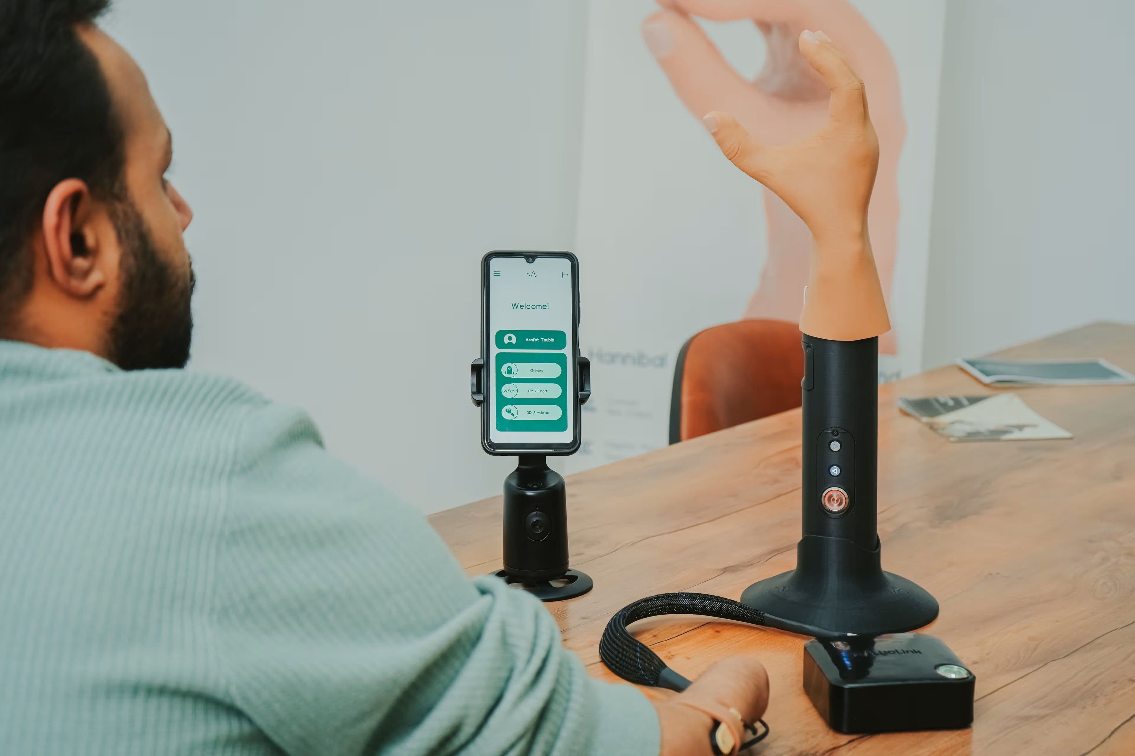 Prosthetics Beyond Borders image showing a prosthetic hand attached to a phone.